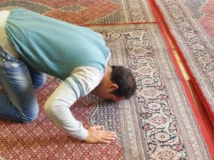 Person prostrating in a Masjid